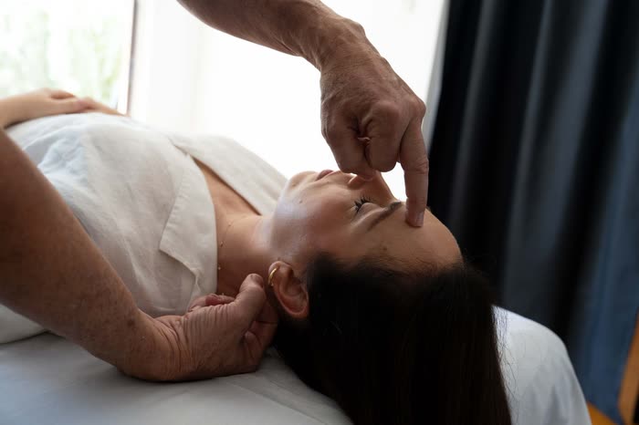 A client lying fully clothed on the treatment table, ready for an acupressure session.
