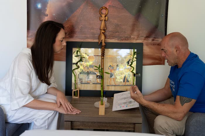 Steve discussing a client's intake notes with her during a brief consultation before an acupressure session.